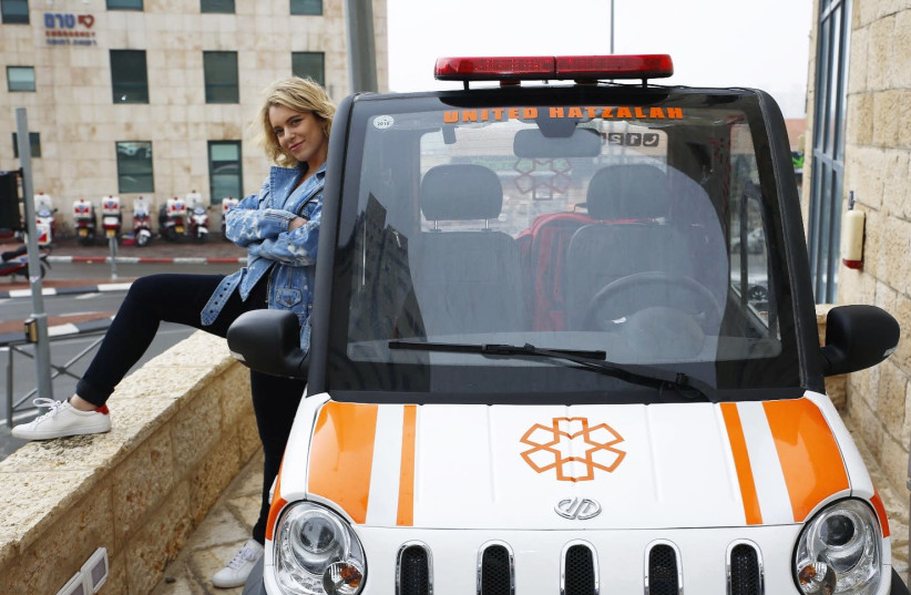 RENEE WILLETT with a lucky United Hatzalah rescue vehicle.  (photo credit: RAPHAEL POCH)