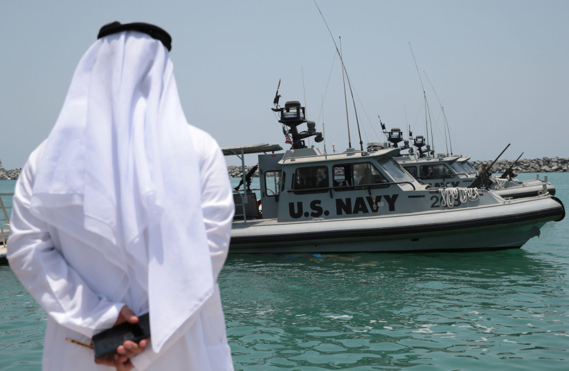 An Emirati official watches members of the U.S. Navy Fifth Fleet as they prepare to escort journalists to tanker at a U.S. NAVCENT facility near the port of Fujairah, United Arab Emirates June 19, 2019. The Fifth Fleet protects oil shipping lanes in he region (photo credit: REUTERS/CHRISTOPHER PIKE)