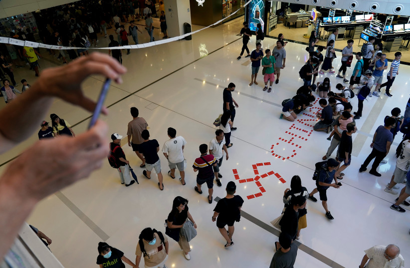  Anti-government protesters place a swastika sign on the floor during a rally in a shopping mall in Sha Tin, Hong Kong, China September 22, 2019. (photo credit: ALY SONG/REUTERS)