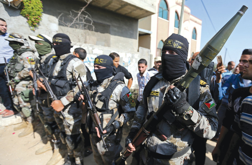 ISLAMIC JIHAD terrorists show off their weapons in the Gaza Strip.  (credit: REUTERS)