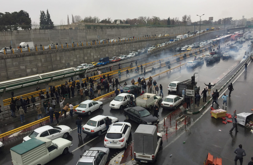 People stop their cars in a highway to show their protest for increased gas price in Tehran, Iran November 16, 2019 (photo credit: NAZANIN TABATABAEE/WANA VIA REUTERS)
