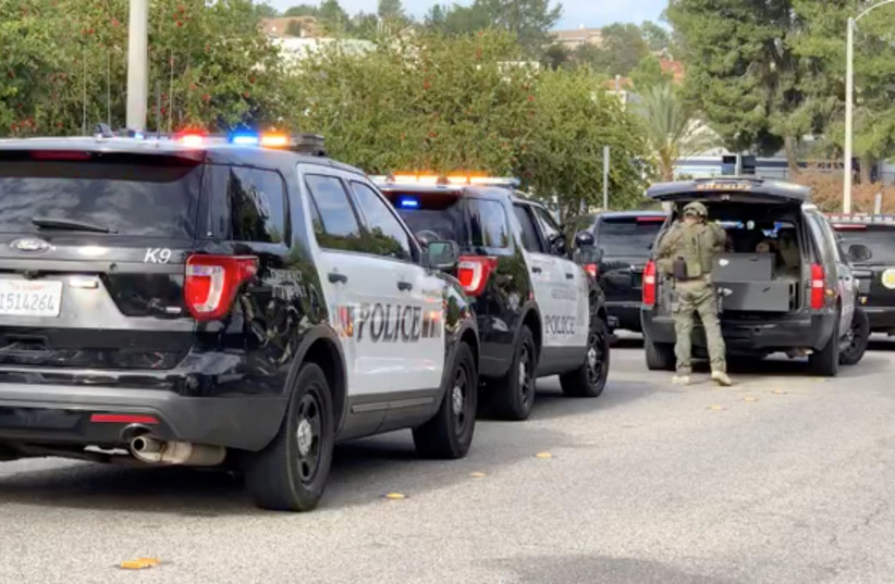 A sheriff puts on tactical gear after a shooting at Saugus High School in Santa Clarita, California, U.S. (photo credit: REUTERS)