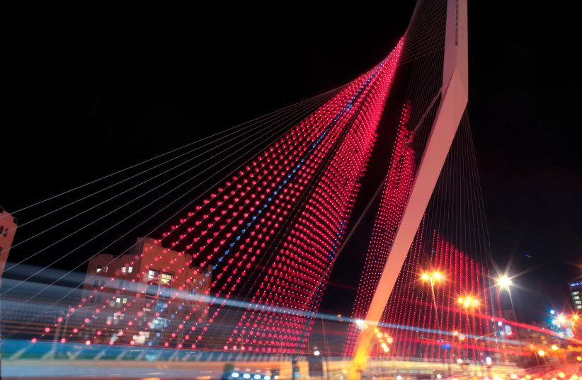 Chords Bridge in Jerusalem is lit in red to mark the need to fight violence against women  (photo credit: TAMIR HAION)