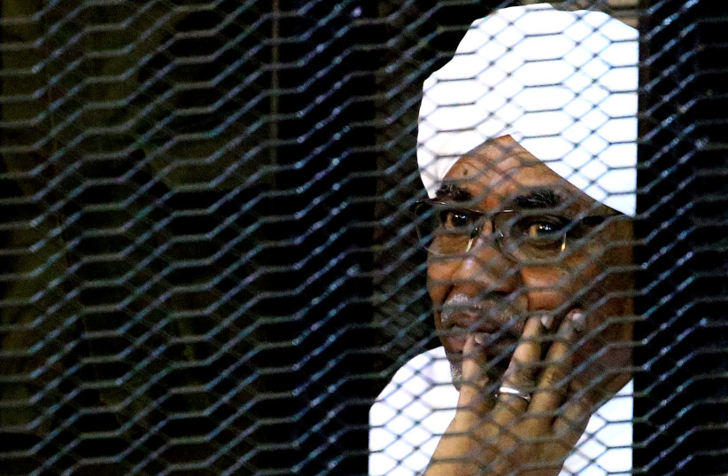 Sudan's former president Omar Hassan al-Bashir sits inside a cage at the courthouse where he is facing corruption charges, in Khartoum, Sudan September 28, 2019 (photo credit: REUTERS/MOHAMED NURELDIN ABDALLAH)