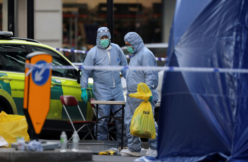 Forensic officers work at the scene of a stabbing on London Bridge, in which two people were killed. (photo credit: REUTERS/SIMON DAWSON)