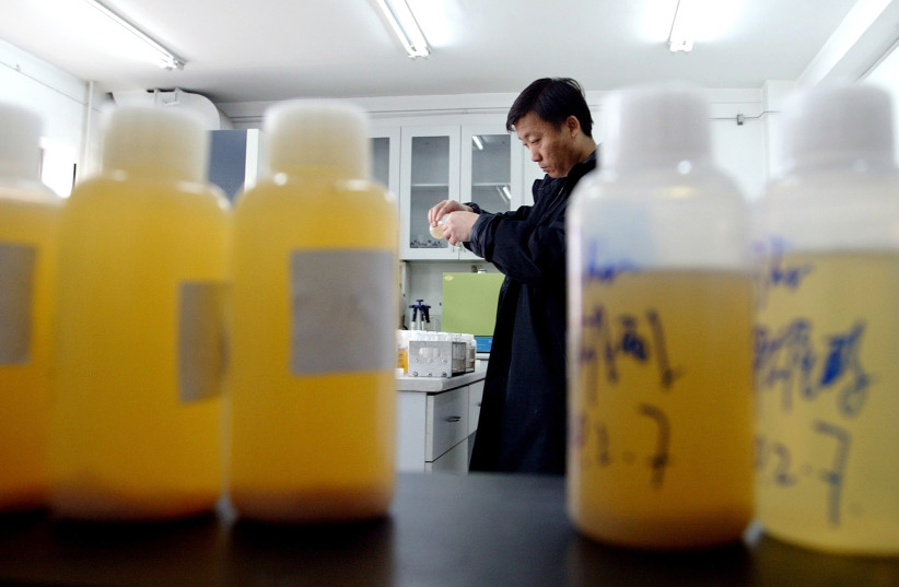 A Chinese laboratory worker inspects urine samples  in Beijing February 9, 2004. (photo credit: GUANG NIU/REUTERS)