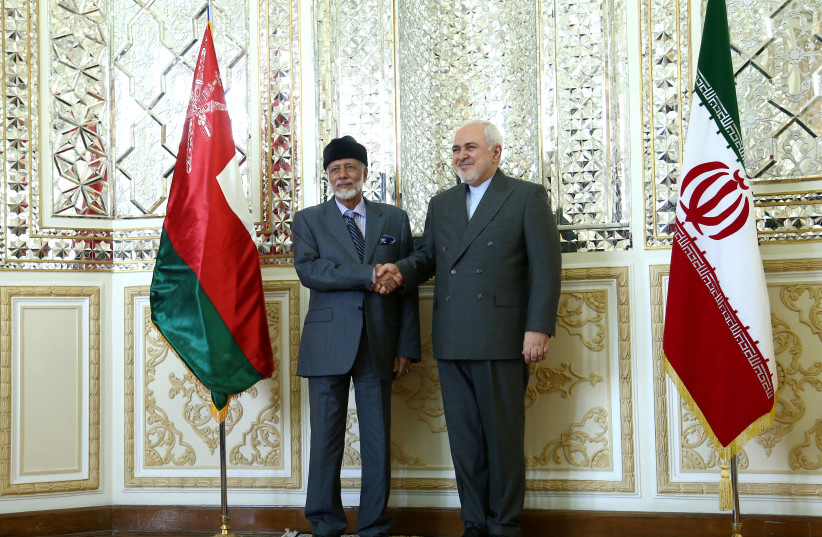 Oman's Minister of State for Foreign Affairs Yousuf bin Alawi bin Abdullah shakes hands with Iran's Foreign Minister Mohammad Javad Zarif in Tehran, Iran July 27, 2019.  (photo credit: NAZANIN TABATABAEE/WANA VIA REUTERS)