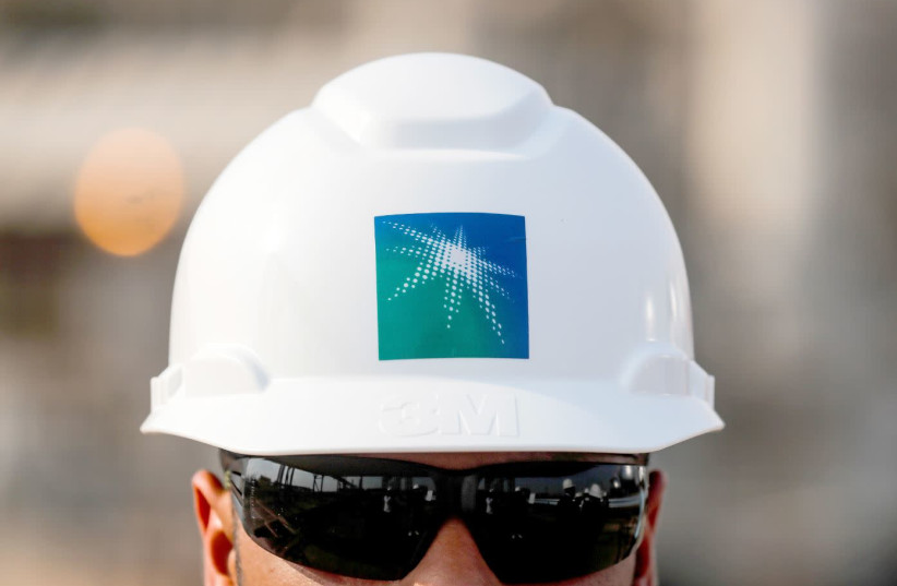 AN EMPLOYEE in a branded helmet is pictured at Saudi Aramco oil facility in Abqaiq, Saudi Arabia, on October 12. (photo credit: MAXIM SHEMETOV/REUTERS)