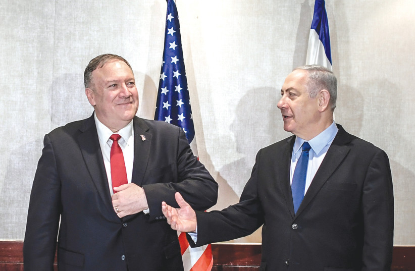 MMUNITY? WHO, ME? Prime Minister Benjamin Netanyahu makes a point on Wednesday to US Secretary of State Mike Pompeo in Lisbon (photo credit: PATRICIA DE MELO MOREIRA/REUTERS)