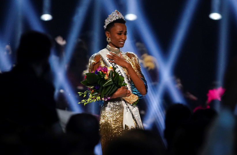 Zozibini Tunzi, of South Africa, takes her first walk as Miss Universe after winning the 2019 Miss Universe pageant at Tyler Perry Studios in Atlanta, Georgia, U.S. December 8, 2019 (photo credit: REUTERS/ELIJAH NOUVELAGE)