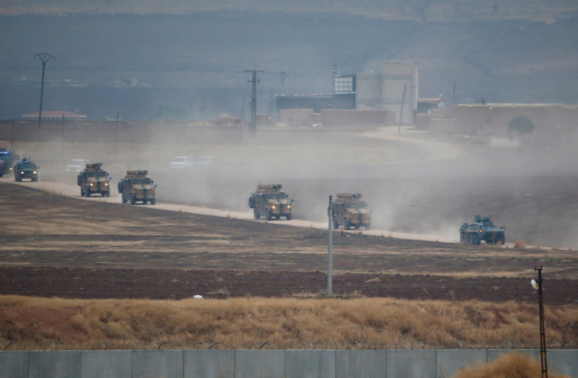 Turkish and Russian military vehicles return following a joint patrol in northeast Syria, as they are pictured from near the Turkish border town of Kiziltepe in Mardin province, Turkey, November 1, 2019 (photo credit: REUTERS/KEMAL ASLAN)