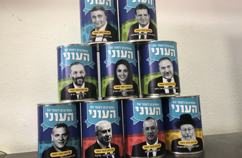 Latet to sell empty cans with politicians' faces as a call to action against poverty (photo credit: RACHEL WOLF)
