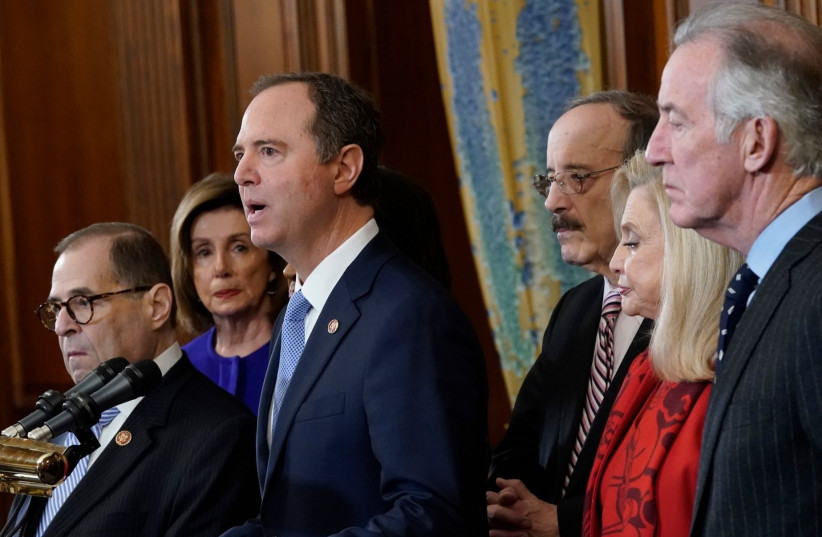 Rep. Adam Schiff, at the microphone, joins with other House committee chairs and Speaker Nancy Pelosi, second from left, to announce the next steps in the House impeachment inquiry, at the U.S. Capitol, Dec. 10, 2019.  (photo credit: WIN MCNAMEE / GETTY IMAGES NORTH AMERICA / AFP)