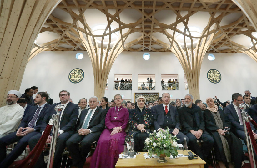 TURKISH PRESIDENT Recep Tayyip Erdogan and wife Emine (behind flowers) attend the official opening of the new Cambridge Central Mosque in Britain on December 5.  (photo credit: REUTERS)