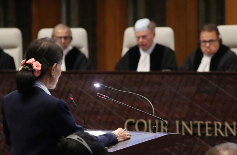 Myanmar's leader Aung San Suu Kyi speaks in front of the judges on the second day of hearings in a case filed by Gambia against Myanmar alleging genocide against the minority Muslim Rohingya population, at the International Court of Justice (ICJ) in The Hague, Netherlands December 11, 2019 (photo credit: YVES HERMAN / REUTERS)