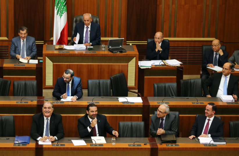 Lebanon's Prime Minister Saad Hariri sits next to Salim Jreissati, Lebanon's minister of state as they attend a parliament session (photo credit: REUTERS/MOHAMED AZAKIR)