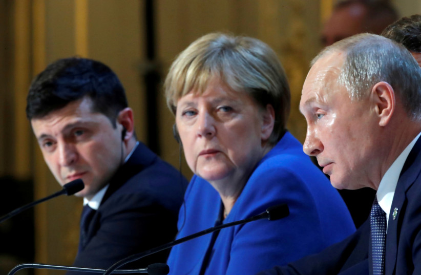 Ukraine's President Volodymyr Zelenskiy, German Chancellor Angela Merkel and Russia's President Vladimir Putin attend a joint news conference after a Normandy-format summit in Paris, France December 10, 2019.  (credit: CHARLES PLATIAU / REUTERS)