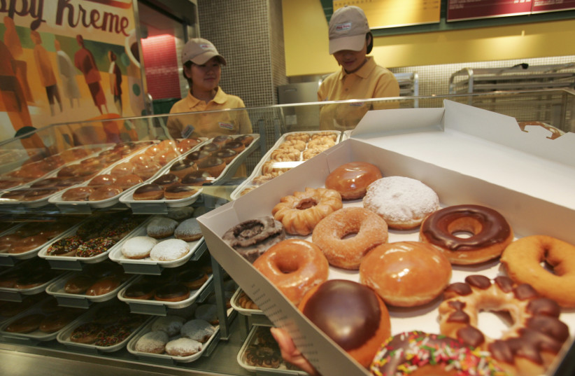 A variety of doughnuts is displayed at new the Krispy Kreme store in Tokyo December 12, 2006. Krispy Kreme Doughnut Inc. opens its first store in Japan on Friday. Picture taken December 12, 2006. (photo credit: TOSHIYUKI AIZAWA/REUTERS)