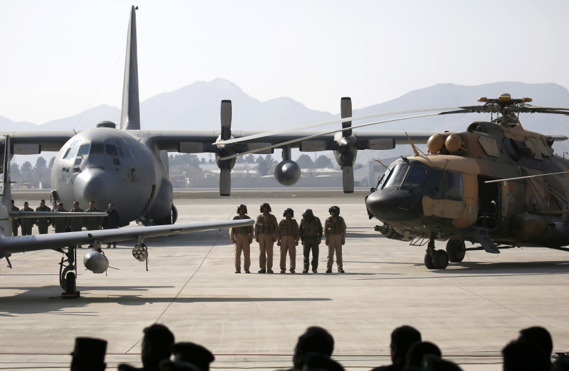 Afghan pilots stand among aircrafts during the Afghanistan Air Force readiness performance program at a military airfield in Kabul (photo credit: REUTERS)
