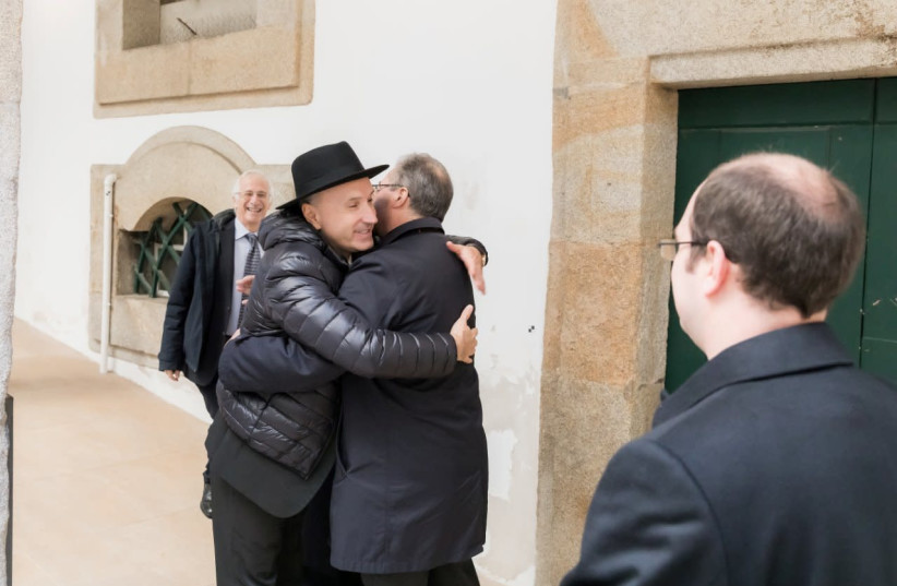 Bishop Manuel Linda and Porto Jewish Community President Diaz Ben Zion embrace at an interfaith event, December 17, 2019.  (photo credit: SUPPLIED)