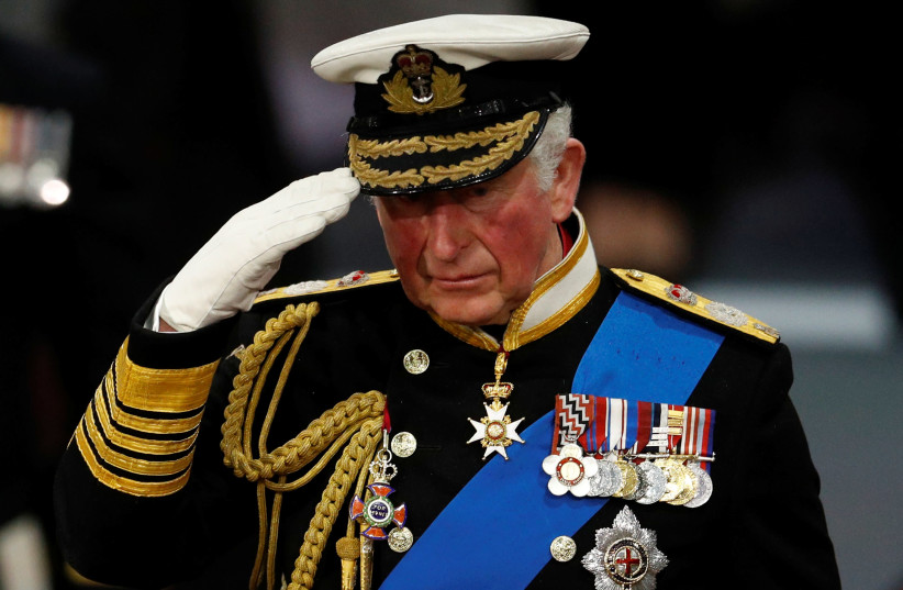 Britain's Prince Charles salutes during the official commissioning ceremony of HMS Prince of Wales, in Portsmouth, Britain December 10, 2019. (photo credit: PETER NICHOLLS/REUTERS)
