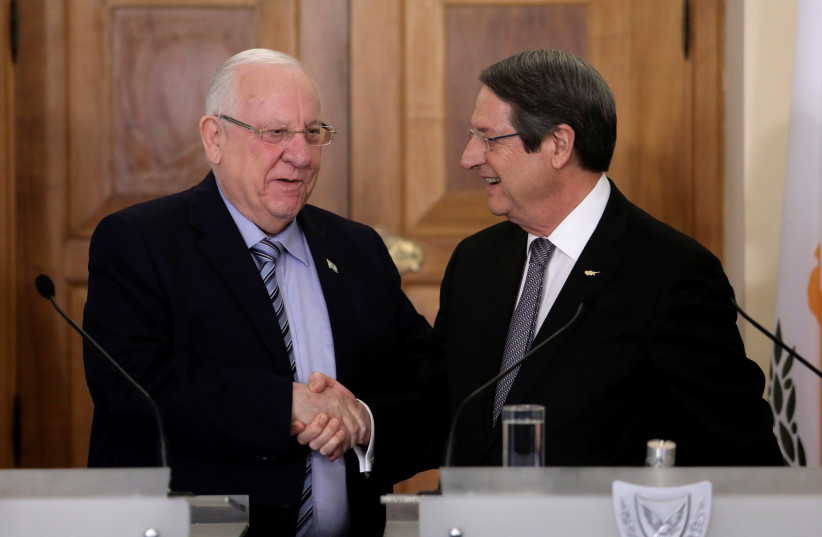 Cypriot President Nicos Anastasiades and Israeli President Reuven Rivlin shake hands during a press conference at the Presidential Palace in Nicosia, Cyprus February 12, 2019 (photo credit: REUTERS/YIANNIS KOURTOGLOU)