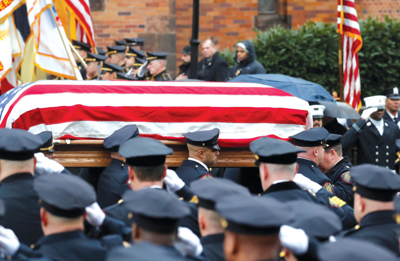 CASKET OF Jersey City Police Detective Joseph Seals carried from St. Aedan’s Church following funeral service in Jersey City. (photo credit: REUTERS)