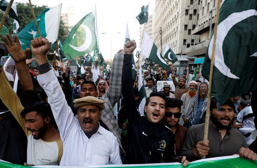 Supporters of Pervez Musharraf chant slogans, after a Pakistani court sentenced the former military ruler to death on charges of high treason and subverting the constitution, during a protest in Karachi, Pakistan, December 18, 2019 (photo credit: REUTERS/AKHTAR SOOMRO)