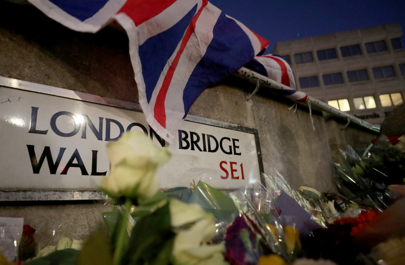 Flowers and tributes to victims are seen on London Bridge in London, Britain December 2, 2019 (photo credit: REUTERS/YVES HERMAN)