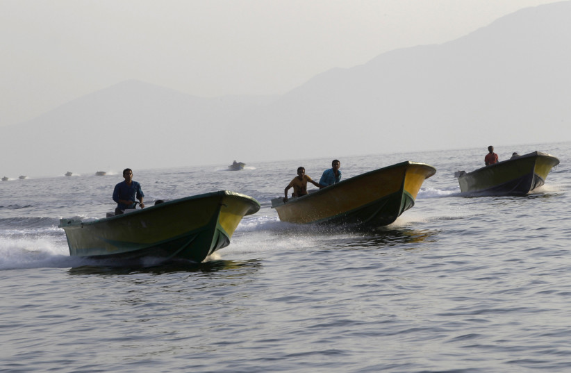 Iranian smugglers drive their boats near the Omani port of Khasab (photo credit: AHMED JADALLAH/REUTERS)