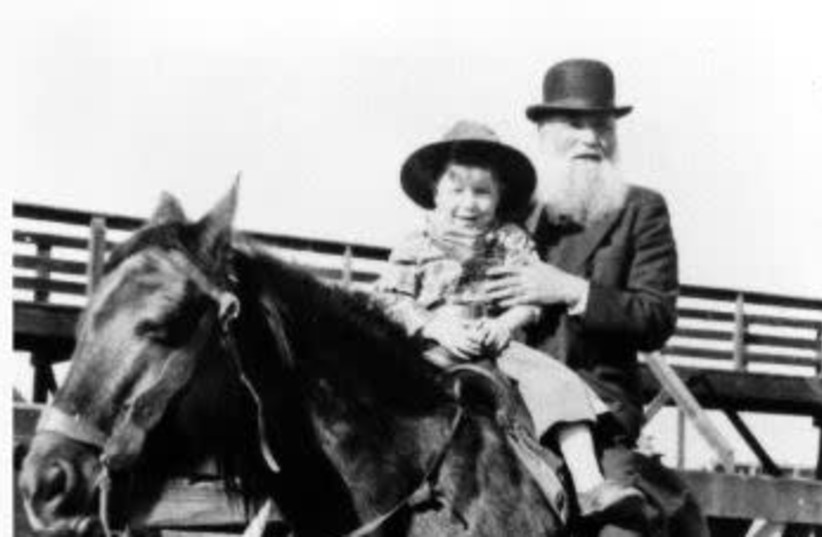 Robert Lazar Miller on horseback with his grandson at the Denver Stockyards, 1932.  (photo credit: BECK ARCHIVES/SPECIAL COLLECTIONS/UNIVERSITY OF DENVER LIBRARIES VIA JTA)