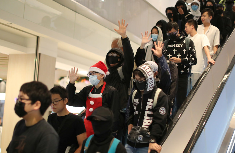 Hong Kong protesters attend a Christmas Day rally in Sha Tin shopping mall in Hong Kong, China, December 25, 2019 (photo credit: REUTERS/LUCY NICHOLSON)