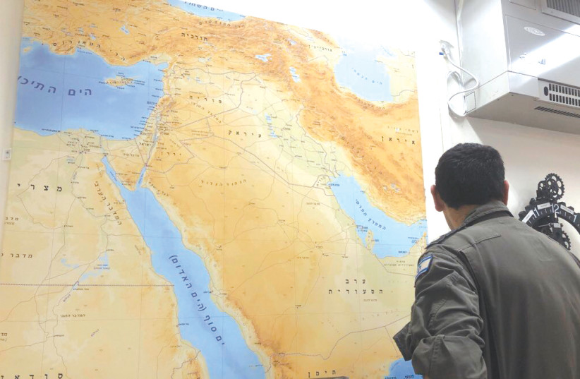 200TH UAV SQUADRON Commander Lt.-Col. Y looks at a map of the Middle East in his office. (photo credit: ANNA AHRONHEIM)