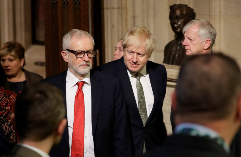 Britain’s Prime Minister Boris Johnson (right)  and Labour Party leader Jeremy Corbyn walk through the Commons Members Lobby during the State Opening of Parliament ceremony at the Palace of Westminster in London on December 19, 2019 (photo credit: REUTERS/KIRSTY WIGGLESWORTH/POOL)