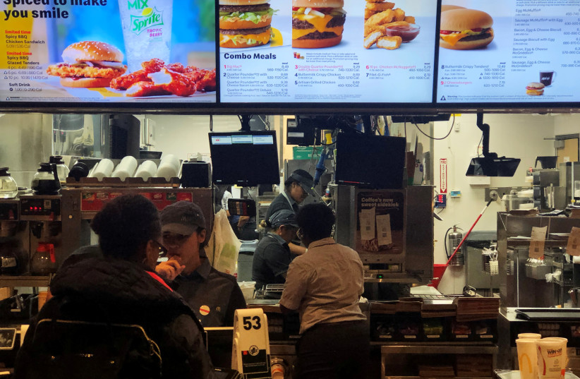 McDonald's employees take orders at the Union Square fast-food chain McDonald's in New York (photo credit: SHANNON STAPLETON / REUTERS)