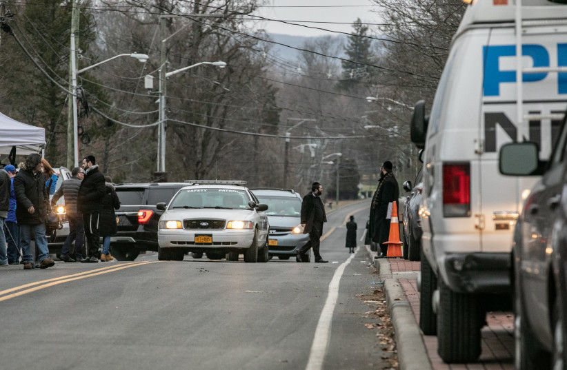 A patrol vehicle is seen near Rabbi Chaim Rottenberg's residence in Monsey, New York, U.S., December 29, 2019 (photo credit: REUTERS/JEENAH MOON)