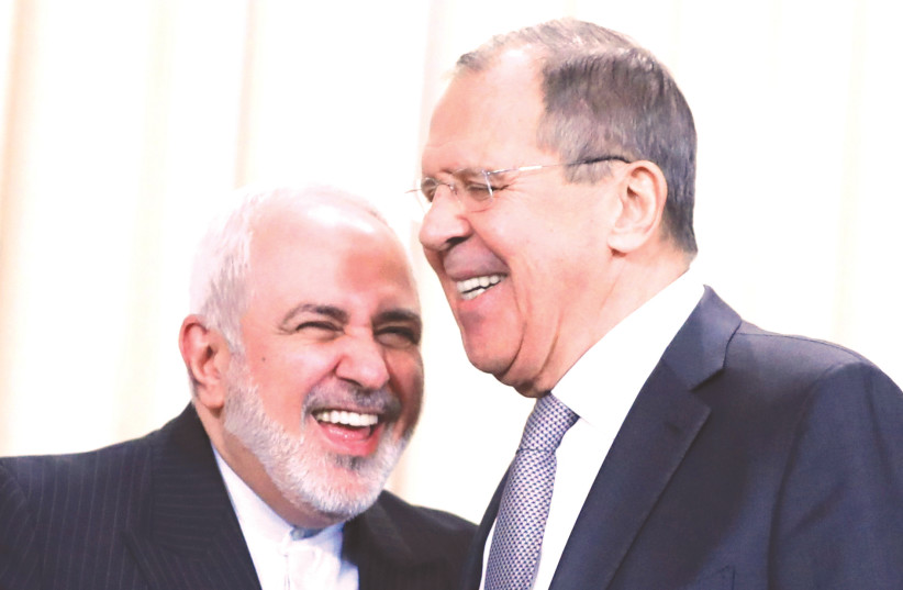 IRAN'S FOREIGN MINISTER Mohammad Javad Zarif shares a laugh with Russia's Foreign Minister Sergei Lavrov in Moscow, Monday (photo credit: EVGENIA NOVOZHENINA/REUTERS)