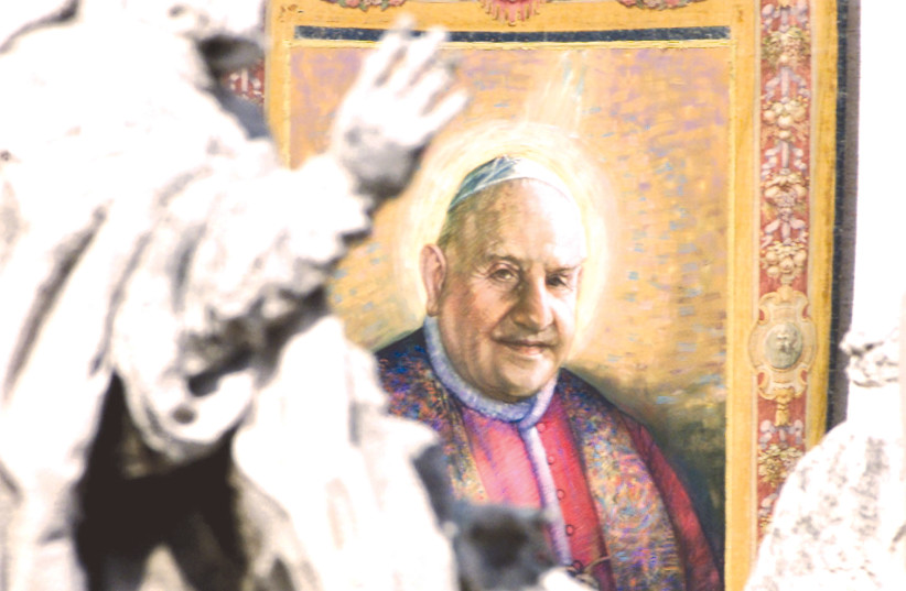 A TAPESTRY with the image of Pope John XXIII (1881-1963) hangs on the facade of St. Peter’s facade during a beatification ceremony celebrated by Pope John Paul II (photo credit: REUTERS)
