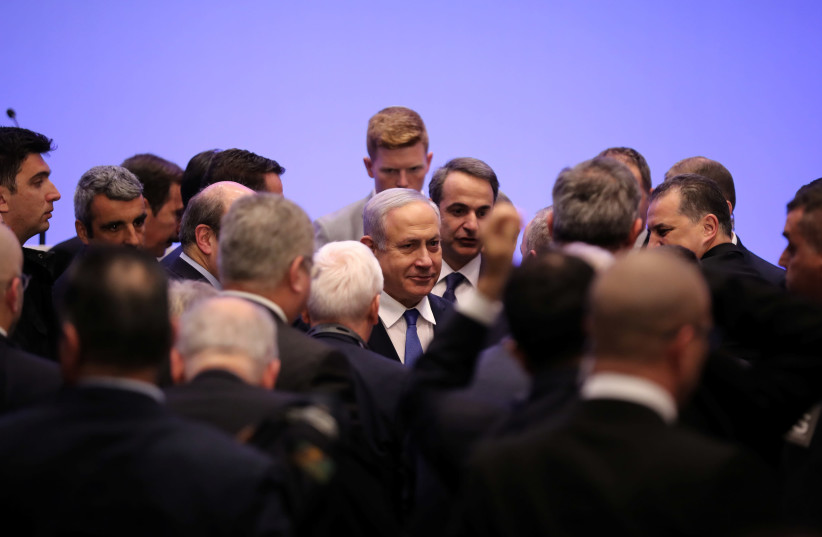 Israeli Prime Minister Benjamin Netanyahu and Greek Prime Minister Kyriakos Mitsotakis are seen following the signing of a deal to build the EastMed subsea pipeline to carry natural gas from the eastern Mediterranean to Europe, at the Zappeion Hall in Athens, Greece, January 2, 2020 (photo credit: ALKIS KONSTANTINIDIS / REUTERS)