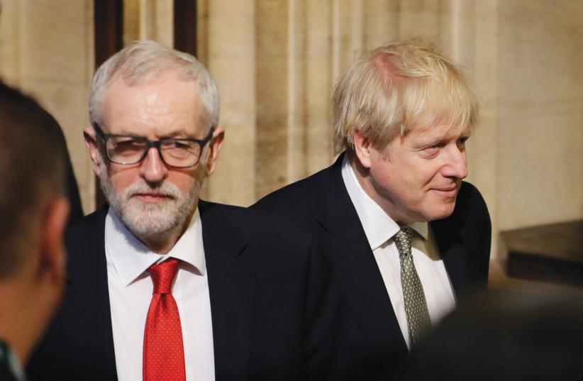 BRITAIN’S PRIME Minister Boris Johnson and Labour Party Leader Jeremy Corbyn walk through the Commons Members Lobby after the Queen’s Speech at the State Opening of Parliament ceremony at the Palace of Westminster in London in December. (photo credit: REUTERS)
