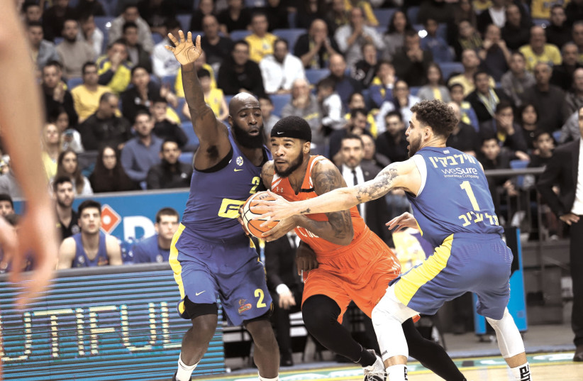 QUINCY ACY (left) and Scottie Wilbekin (right) helped shut down Jeremy Hollowell (center) and Ness Ziona late in Maccabi Tel Aviv’s 80-71 victory in Winner League action. (photo credit: ADI AVISHAI)