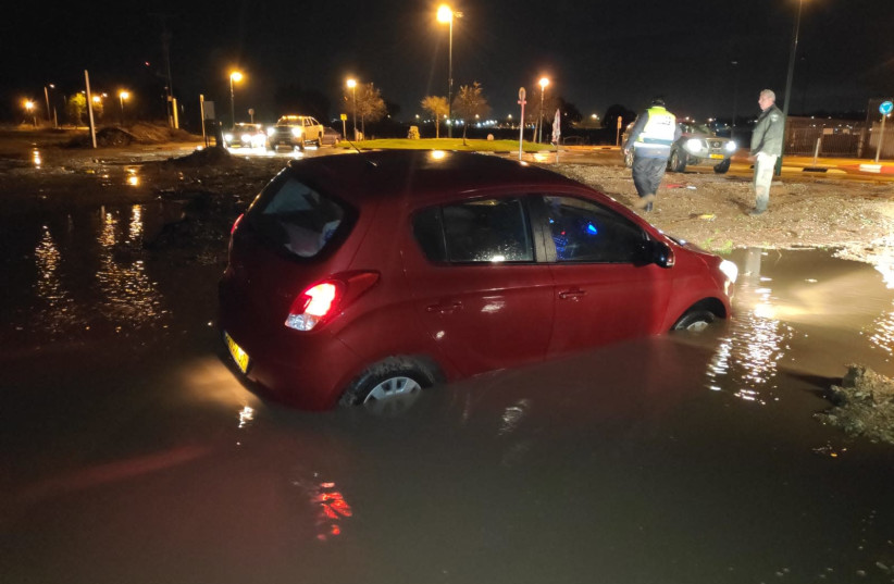 A vehicle submerged in water in northern Israel as a result of heavy rains (photo credit: OHAD AMITON/TPS)