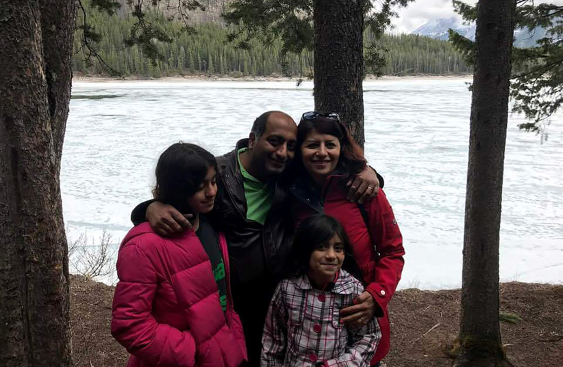 Victims of the Ukraine International Airlines crash in Iran, University of Alberta professors Mojgan Daneshmand and Pedram Mousavi, pose with their daughters Daria and Dorina Mousavi in an undated family photo. (photo credit: REUTERS)