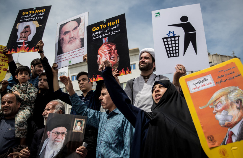 Iranians shout slogans during a protest against President Donald Trump's decision to walk out of a 2015 nuclear deal, in Tehran, Iran, May 11, 2018. (credit: REUTERS/TASNIM NEWS AGENCY)