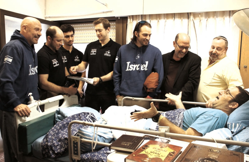 MEMBERS OF Israel’s Olympic-bound national baseball team visit with patients at the Sheba Medical Center at Tel HaShomer yesterday (photo credit: MARGO SUGARMAN)