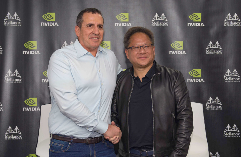 Mellanox CEO Eyal Waldman and Nvidia CEO Jensen Huang shake hands after Nvidia completed a $6.9b. acquisition of the Israeli company in March 2019 (photo credit: OMER TAL)