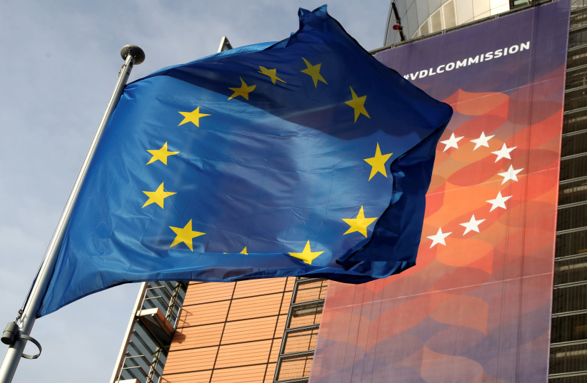 A European Union flag flies outside the European Commission headquarters in Brussels, Belgium, December 19, 2019. (credit: REUTERS/YVES HERMAN)