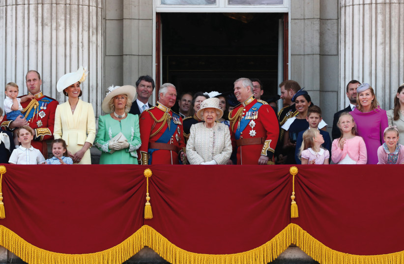 Queen Elizabeth, Prince Charles, Prince Harry, Prince William and Catherine, Duchess of Cambridge, along with other members of the British royal family, appear on the balcony as the Royal Air Force Aerobatic Team Red Arrows performs a flypast during Trooping the Colour parade in London on June 8, 20