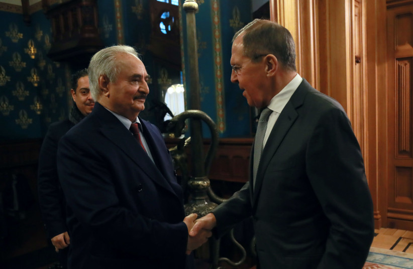 Commander of the Libyan National Army (LNA) Khalifa Haftar shakes hands with Russian Foreign Minister Sergei Lavrov before talks in Moscow, Russia January 13, 2020. (photo credit: MINISTRY OF FOREIGN AFFAIRS OF THE RUSSIAN FEDERATION/HANDOUT VIA REUTERS)