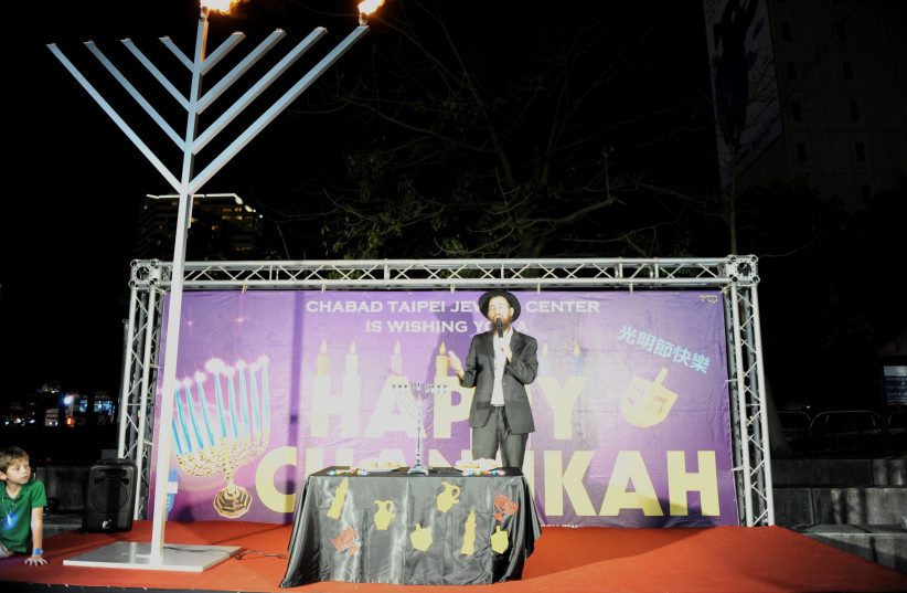 RABBI SHLOMI TABIB lights Hanukkah candles at Taipei 10 (photo credit: Courtesy)